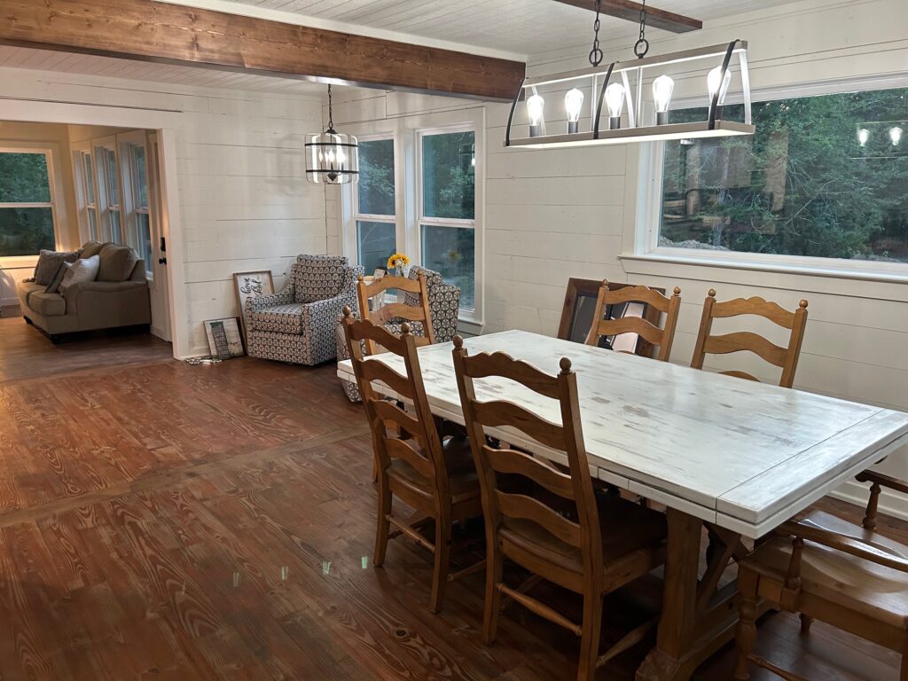 Dining area with farmhouse table in a custom home built by 1802 Build Co.