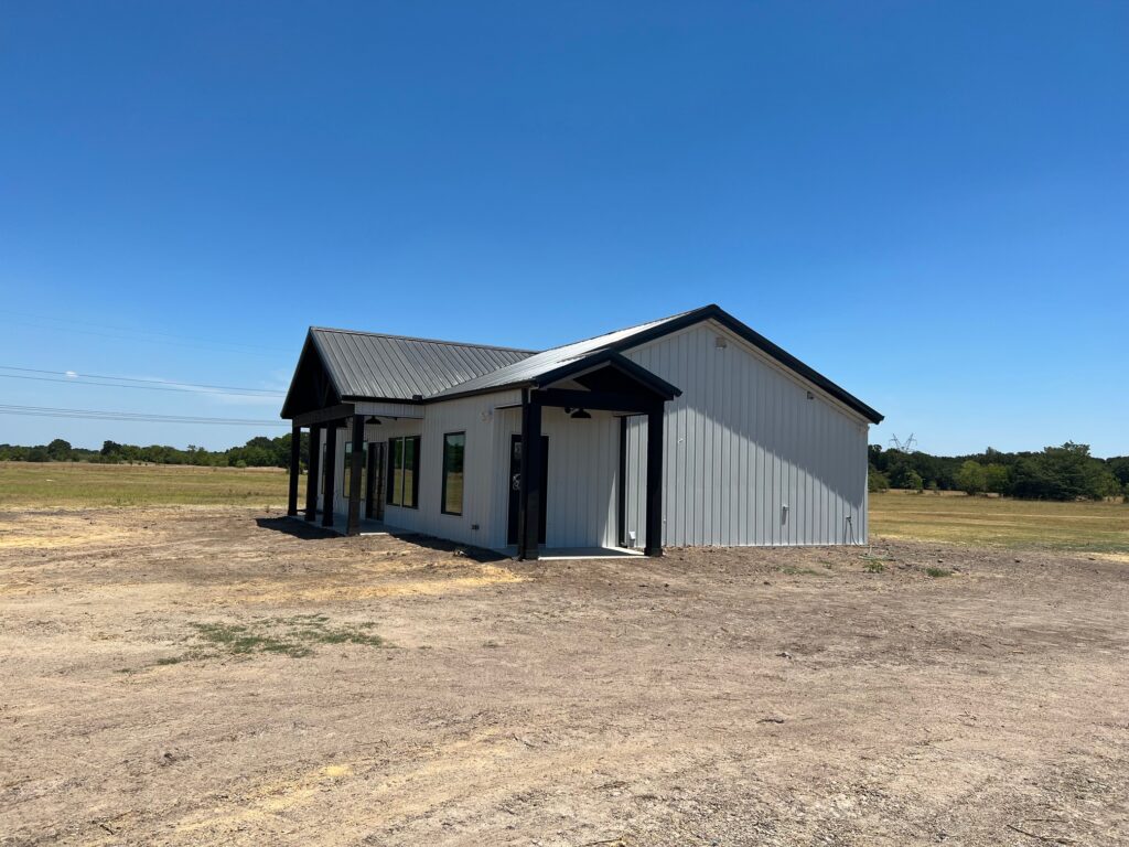 Questions to ask a barndominium builder: a finished metal barndominium on open acreage by 1802 Build Co. in East Texas