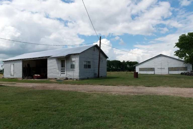 Metal farm buildings on open land near Terrell, Texas
